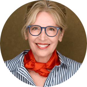 A close-up of an open notebook with a pen and a white coffee cup on a saucer, set against a blurred city background.